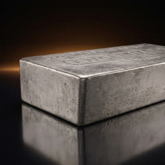 Engelhard 100 oz silver bar seen low from the long side, showing its thick side face and a corner