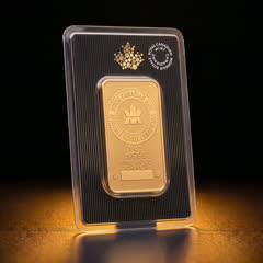 Royal Canadian Mint 1 oz gold bar in its black assay card, front, turned to a side angle